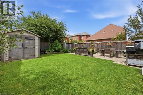 Expansive grassy yard with a paver patio and a storage shed - 738 Fourth Line, Milton, ON - Outdoor