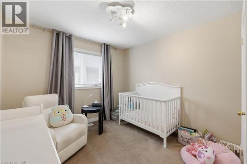 Neutral wall tones, carpeted flooring, a ceiling-mounted light fixture, and a window with blinds - 738 Fourth Line, Milton, ON - Indoor Photo Showing Bedroom