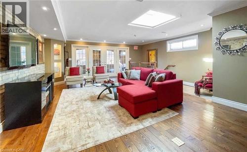 Hardwood flooring, recessed lighting, skylight, and French doors - 453 Brant Street, Burlington, ON 