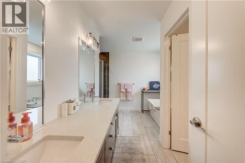 Dual vanity with integrated sinks and a light-toned countertop - 1061 Eagletrace Drive Unit# 174, London, ON - Indoor Photo Showing Bathroom