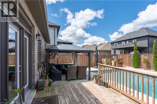 Expansive wood deck with a built-in swimming pool, adjacent to a covered gazebo - 1061 Eagletrace Drive Unit# 174, London, ON - Outdoor With Deck Patio Veranda With Exterior