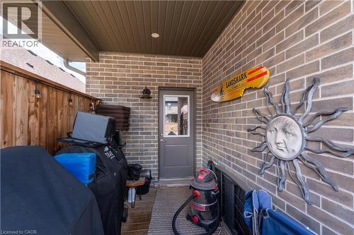 Covered patio featuring a brick accent wall, wood-finish privacy fence, and recessed lighting - 1061 Eagletrace Drive Unit# 174, London, ON -  Photo Showing Other Room
