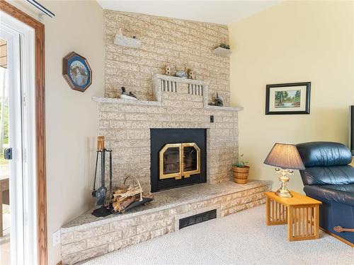 34 Thorvaldson Drive, Arnes, MB - Indoor Photo Showing Living Room With Fireplace