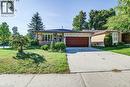 Brick facade, covered front porch, attached garage with a panel door, concrete driveway, and front lawn - 3 Cora Drive, Kitchener, ON  - Outdoor 