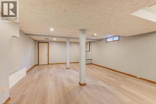 Spacious room featuring wood-finish flooring, recessed lighting, and light gray walls - 3 Cora Drive, Kitchener, ON - Indoor Photo Showing Basement