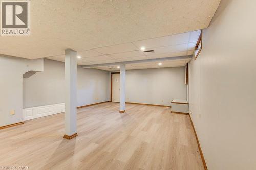 Recessed lighting illuminates the space, featuring light wood-finish flooring and a drop ceiling - 3 Cora Drive, Kitchener, ON - Indoor Photo Showing Basement