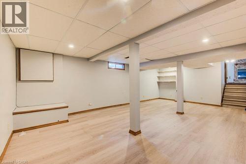 Versatile basement space featuring blonde wood-finish flooring, recessed ceiling lighting, and structural support columns - 3 Cora Drive, Kitchener, ON - Indoor Photo Showing Basement