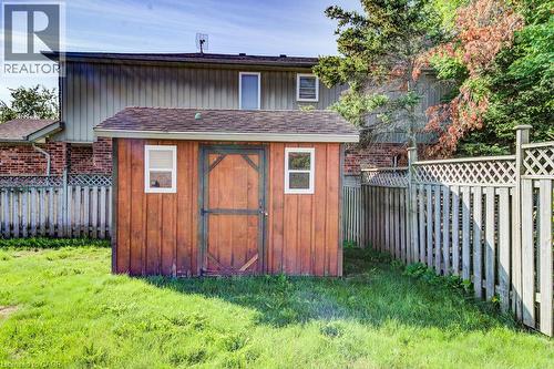 Wood-sided storage shed with a shingle roof and two windows - 3 Cora Drive, Kitchener, ON - Outdoor
