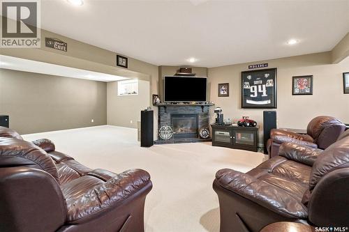 211 Crenshaw Way, Warman, SK - Indoor Photo Showing Basement With Fireplace