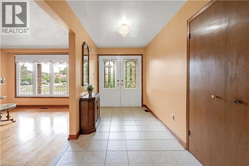 Entryway featuring ceramic tile flooring, double entry doors with decorative glass inserts, and a flush mount ceiling fixture - 2535 Privet Crescent, Mississauga, ON - Indoor Photo Showing Other Room