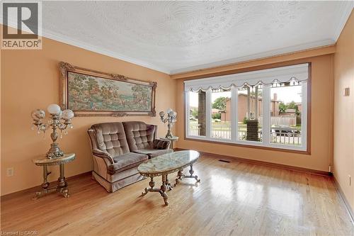 Hardwood flooring, crown molding, large picture window, textured ceiling, and neutral wall color - 2535 Privet Crescent, Mississauga, ON - Indoor Photo Showing Living Room