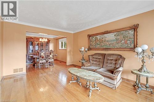 Hardwood flooring, crown molding, and a defined dining area with a chandelier - 2535 Privet Crescent, Mississauga, ON - Indoor Photo Showing Living Room