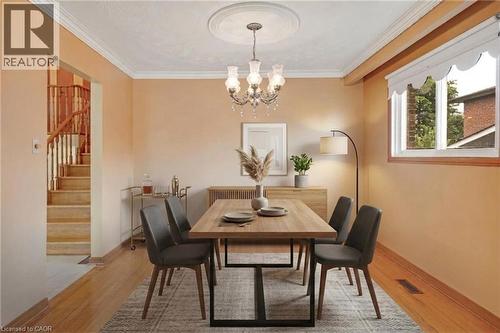 *VIRTUALLY STAGED* Hardwood-finish flooring, crown molding, cased openings, recessed windows, and a decorative ceiling medallion with a chandelier - 2535 Privet Crescent, Mississauga, ON - Indoor Photo Showing Dining Room