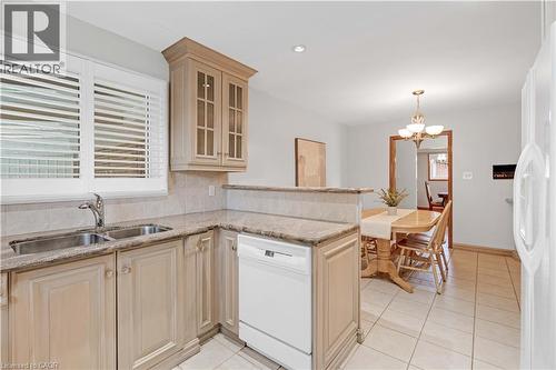 Kitchen with light-toned cabinetry, granite-finish countertops, and a double basin stainless steel sink - 2535 Privet Crescent, Mississauga, ON - Indoor Photo Showing Kitchen With Double Sink