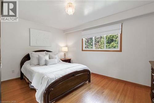 Wood-finish flooring with baseboard trim - 2535 Privet Crescent, Mississauga, ON - Indoor Photo Showing Bedroom