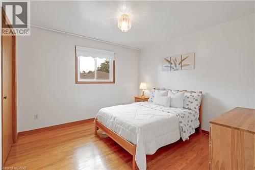 Wood-finish flooring, single window, white walls, and a ceiling-mounted light fixture - 2535 Privet Crescent, Mississauga, ON - Indoor Photo Showing Bedroom