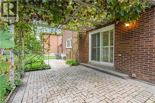 Brick exterior with an overhead trellis structure featuring abundant foliage - 2535 Privet Crescent, Mississauga, ON - Outdoor