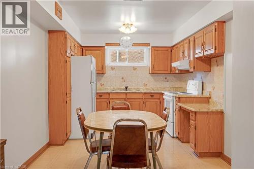 Light wood-finish cabinetry, solid surface countertops, and light wood-finish flooring - 2535 Privet Crescent, Mississauga, ON - Indoor