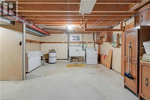 Unfinished basement with exposed ceiling joists, concrete flooring, and a utility sink - 2535 Privet Crescent, Mississauga, ON - Indoor Photo Showing Basement