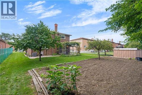 Expansive backyard featuring a large garden area, mature trees, manicured lawn, and brick exterior - 2535 Privet Crescent, Mississauga, ON - Outdoor