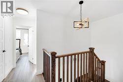 Wood-finish flooring throughout the hallway and room - 