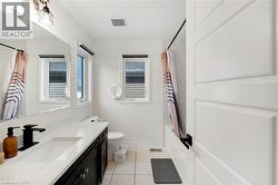 Modern bathroom featuring a rectangular undermount sink, black-finish faucet, and a large vanity mirror - 