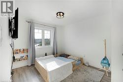 Window with exterior scenery, overhead lighting fixture, and wood-finish flooring - 
