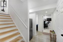 Wood-finish staircase with white risers and handrail - 