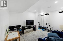 Recessed lighting, wood-finish flooring, and white walls - 