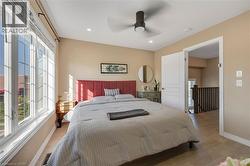 Recessed lighting, ceiling fan, wood-finish flooring, paneled interior door, and large multi-pane windows - 