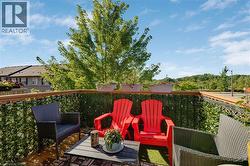 Deck with wood flooring and a privacy screen - 