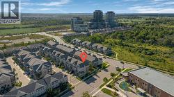 Townhome property in a developed community with surrounding green spaces and nearby high-rise buildings - 