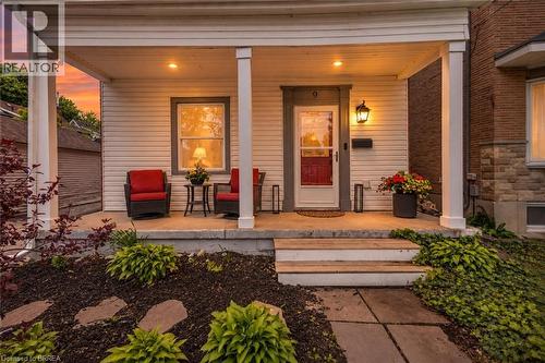 Twilight image has been AI-generated from the original exterior photo for illustrative purposes - 9 Aylmer Street, Brantford, ON 