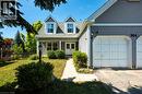 Classic Colonial-style residence featuring a mansard roof with dual dormers, vinyl siding exterior, and a two-car attached garage - 364 Stoneheight Place, Waterloo, ON 
