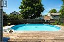 Backyard featuring a built-in swimming pool with a surrounding wood-finish deck - 364 Stoneheight Place, Waterloo, ON 