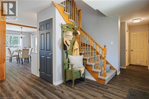 Wood-finish flooring throughout, with a carpeted staircase featuring wood banisters - 364 Stoneheight Place, Waterloo, ON 