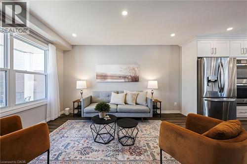 Recessed lighting, wood-finish flooring, white double-hung windows, stainless steel appliances, and white cabinetry - 364 Stoneheight Place, Waterloo, ON 
