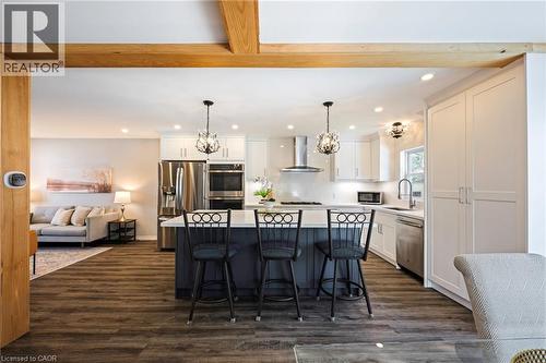 Spacious kitchen featuring a central island with seating, white cabinetry, stainless steel appliances, and recessed lighting - 364 Stoneheight Place, Waterloo, ON 