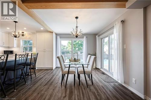 Open-concept living area featuring wood-finish flooring, exposed ceiling beams, and recessed lighting - 364 Stoneheight Place, Waterloo, ON 