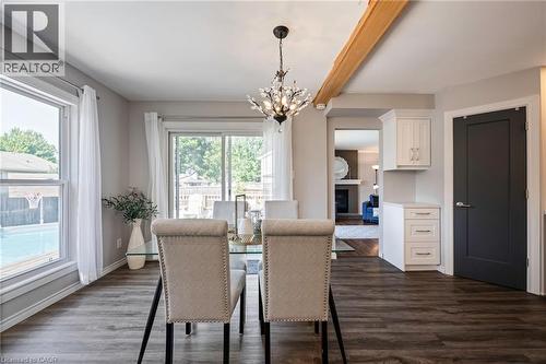 Wood-finish flooring throughout, with a decorative chandelier, and a wood beam accent - 364 Stoneheight Place, Waterloo, ON 
