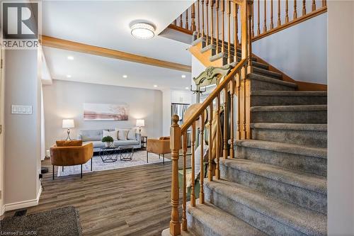 Carpeted staircase with wood-finish handrails, recessed lighting, wood-finish flooring, and exposed ceiling beams - 364 Stoneheight Place, Waterloo, ON 