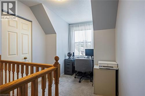 Window with natural light, sloped ceilings, bi-fold closet door, and carpeted flooring - 364 Stoneheight Place, Waterloo, ON 