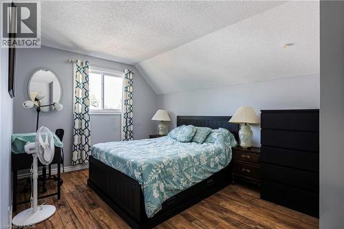 Wood-finish flooring with a window offering natural light, textured ceiling, and painted walls - 364 Stoneheight Place, Waterloo, ON 