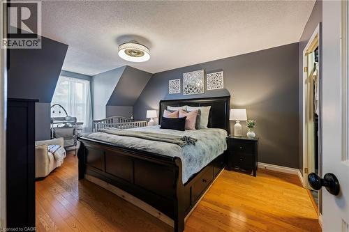 Hardwood flooring, painted walls, ceiling fan, window with sheer drapery, and a built-in closet with an open door - 364 Stoneheight Place, Waterloo, ON 