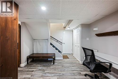 Wood-finish flooring, drop ceiling, built-in desk, built-in storage, and recessed lighting - 364 Stoneheight Place, Waterloo, ON 
