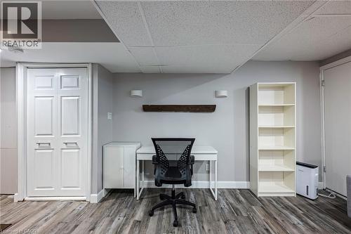 Wood-finish flooring with light gray walls, a ceiling tile finish, and white bi-fold doors - 364 Stoneheight Place, Waterloo, ON 