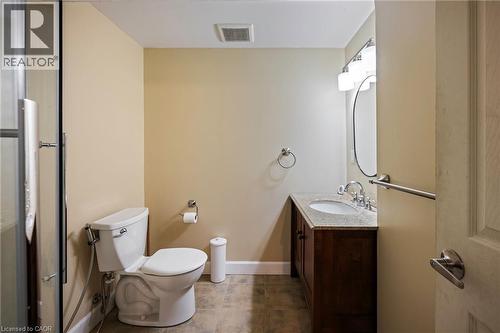 Bathroom featuring a dark wood-finish vanity, light-toned countertop, under-mount sink, and tiled flooring - 364 Stoneheight Place, Waterloo, ON 