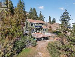 Perched above Okanagan Lake on 1.77 private acres, surrounded by nature and panoramic lake and mountain views - 