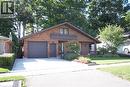 Brick exterior with a peaked roofline, a single-car garage, and a concrete driveway - 185 Southwood Drive, Kitchener, ON 