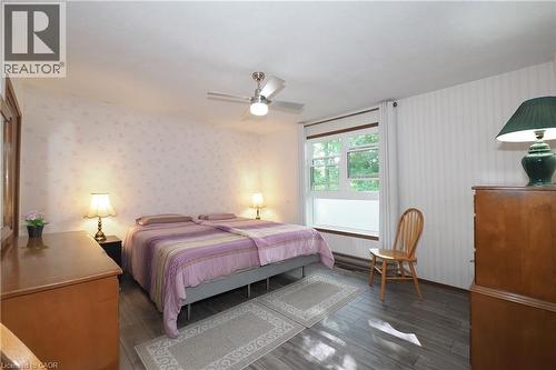 Ceiling fan with integrated lighting, wood-finish flooring, multiple windows, and patterned wall covering - 185 Southwood Drive, Kitchener, ON 